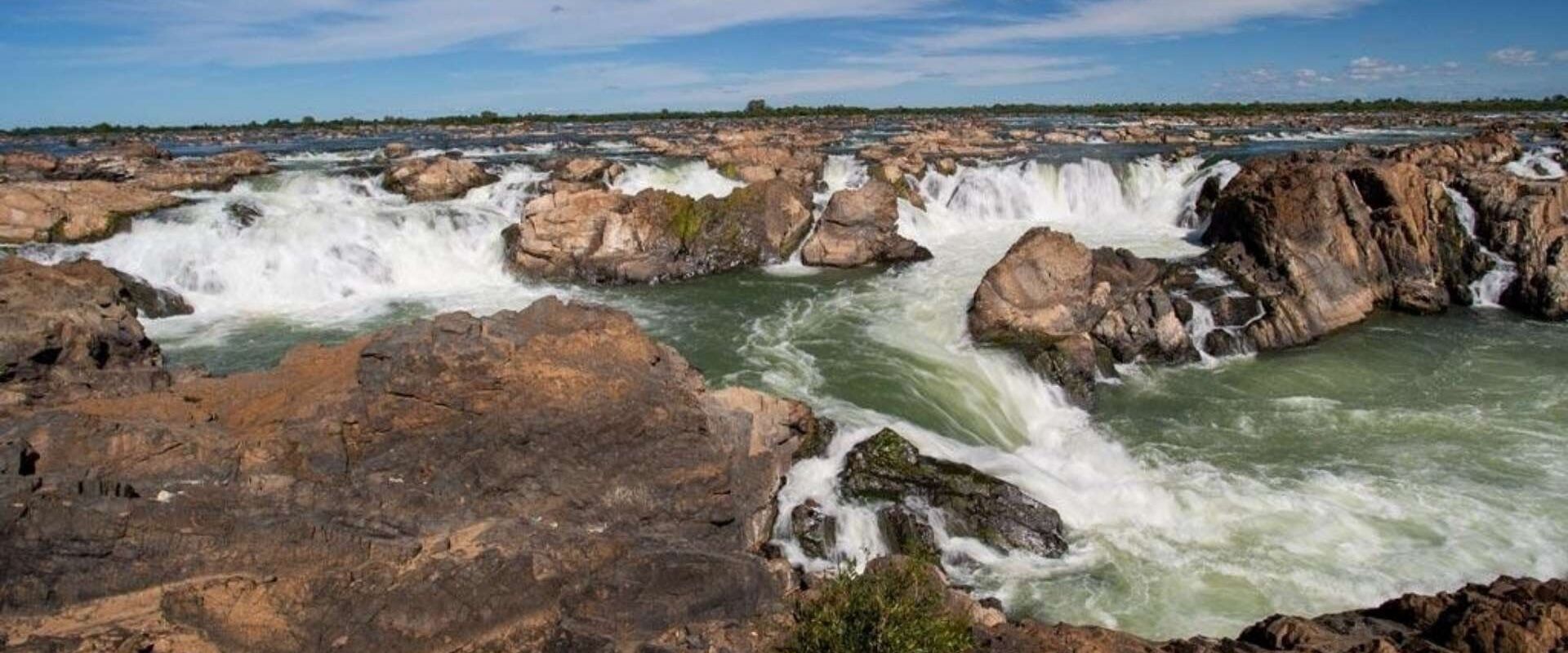 Mekong River rapids in Stung Treng on a scenic Stung Treng Travel banner by Legend Travel Group.